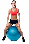 Woman In Gym Relaxing On Pilates Ball Stock Photo