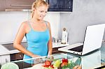 Woman In Kitchen With Laptop Stock Photo