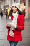 Woman In Red Coat And Wool Cap And Gloves With Smartphone In Han Stock Photo