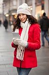 Woman In Red Coat And Wool Cap And Gloves With Smartphone In Han Stock Photo