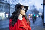 Woman In Red Coat With Smartphone In Hands Going Through The Cit Stock Photo