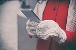 Woman In Red Coat With Smartphone In Hands Going Through The Cit Stock Photo