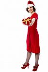 Woman In Red Giving Away Xmas Gift Stock Photo