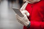 Woman In Wool Gloves Hold Smart-phone Stock Photo