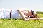 Woman Laying On Field Stock Photo