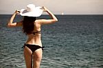 Woman Looking Out At Ocean Stock Photo