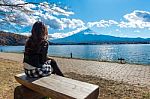 Woman Looking To Fuji Mountains At Kawaguchiko Lake, Japan Stock Photo