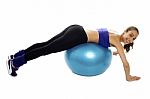 Woman Lying Over Swiss Ball To Strengthen Her Abdomen Stock Photo
