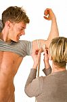 Woman Measuring Biceps Of Young Man Stock Photo