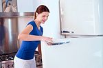 Woman Opening Refrigerator Stock Photo