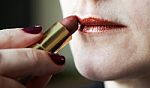 Woman Paints Lips With Lipstick Stock Photo