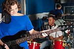 Woman Playing Guitar In Recording Studio Stock Photo