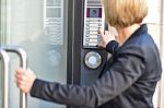 Woman Pushing A Intercom Button Stock Photo