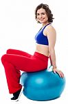 Woman Relaxing On Big Exercise Ball After Workout Stock Photo