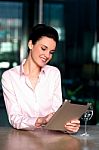 Woman Selecting Menu On Digital Tablet Stock Photo