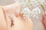 Woman Smelling White Flower Stock Photo