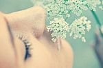 Woman Smelling White Flower Stock Photo