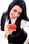 Woman Smiling And Holding A Small Red Heart Stock Photo