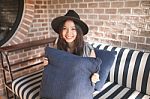 Woman Smiling Near Rustic Brick Wall Stock Photo