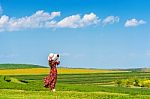 Woman Standing On Green Grass In Green Tea Field Stock Photo