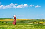 Woman Standing On Green Grass In Green Tea Field Stock Photo