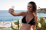 Woman Taking Self Portrait At Beach Stock Photo