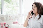 Woman Talking To Cellphone For Her Business In Balcony Stock Photo