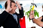 Woman Threatening Her Boss, Holding Hammer Stock Photo