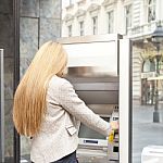 Woman Using Bank ATM Stock Photo