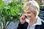 Woman Using Cell Phone Outdoors In City Stock Photo