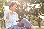 Woman Using Digital Tablet In Park Stock Photo