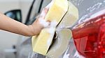 Woman Washing A Car With A Sponge And Soap Stock Photo