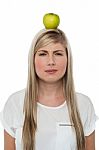 Woman With Apple On Her Head Stock Photo