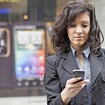 Woman With Cell Phone Walking Stock Photo