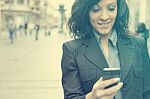 Woman With Cellphone Walking On Street Stock Photo