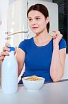 Woman With Cereal And Milk Stock Photo