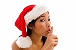 Woman With Christmas Hat And Gesturing To Keep Silent Stock Photo