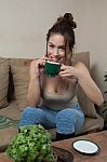 Woman With Coffee Cup On Ceramic Table And Mobile Phone Stock Photo