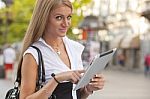 Woman With Ipad Tablet Computer Walking On Urban Street Stock Photo