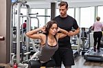 Woman With Personal Trainer  In Gym Stock Photo