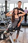 Woman With Personal Trainer  In Gym Stock Photo