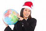 Woman With Santa Hat And Globe Stock Photo