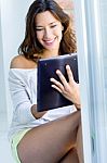 Woman With Tablet At Home Stock Photo