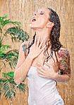 Woman With Tattoos Under Shower Stock Photo