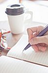 Woman Writing A Plan On Notebook Stock Photo