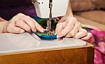 Woman's Hands Sewing On The Sewing Machine Stock Photo