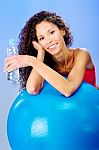 Women Behind Blue Pilates Ball Holding Bottle Of Water Stock Photo