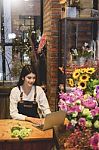 Women Florist Looking Laptop Got Order At Counter Of Her Flower Stock Photo