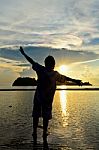 Women Happy Sunrise At The Beach Stock Photo