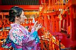 Women In Traditional Japanese Kimonos At Fushimi Inari Shrine In Kyoto, Japan Stock Photo